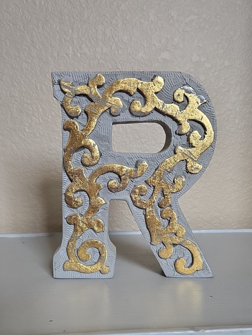 Decorative Gray and Gold Letter R Accent